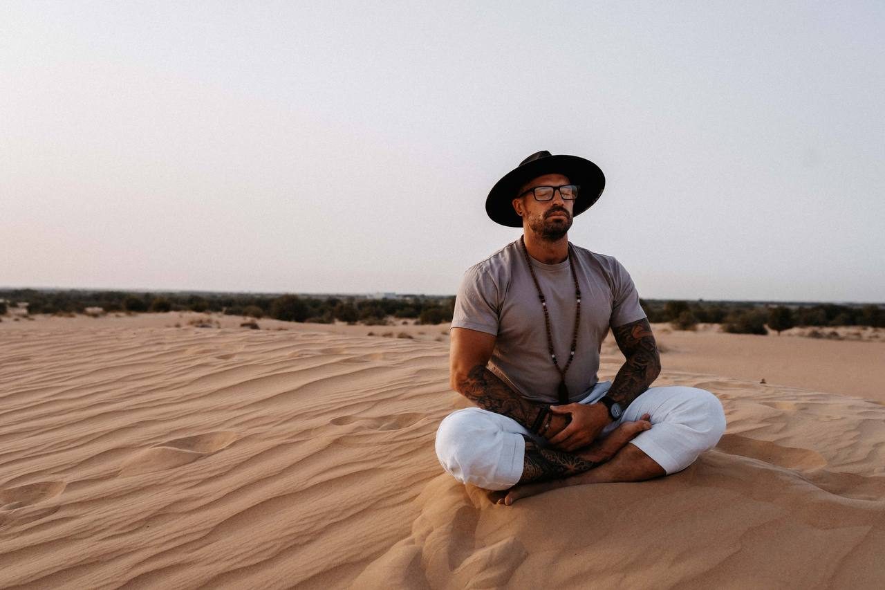 Ashley Edelman sitting in the desert at dusk