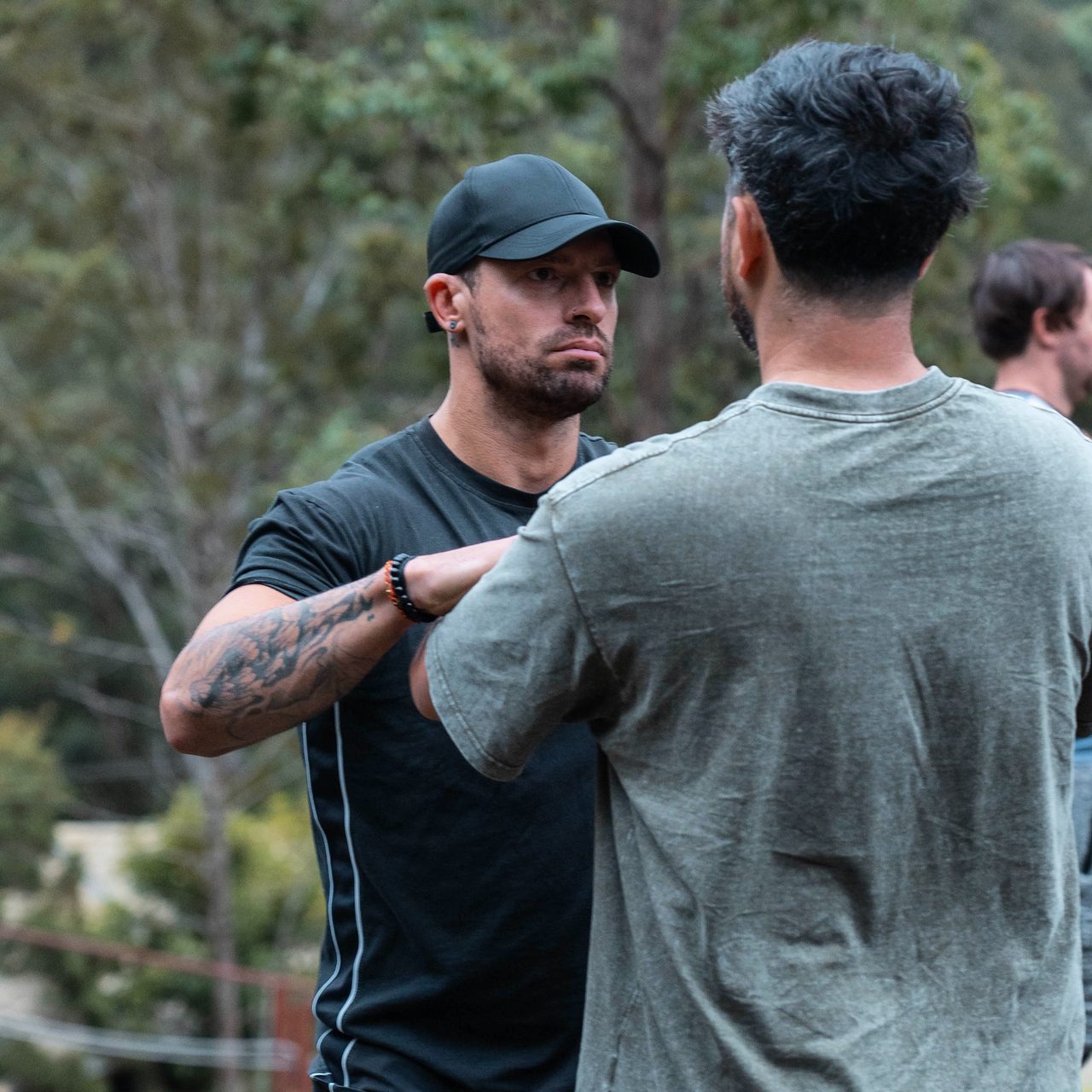 Ashley Edelman working with a man, hand on his shoulder